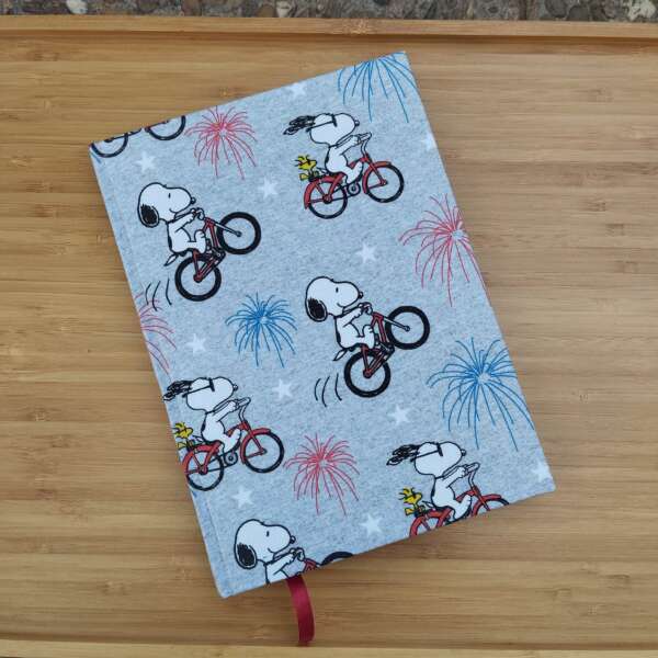 Cuaderno Snoopy en bicicleta